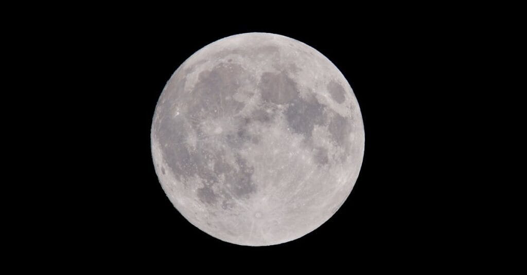 Stunning full moon against a dark night sky, showcasing captivating lunar details.